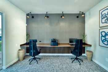 a large office space with a desk and two chairs